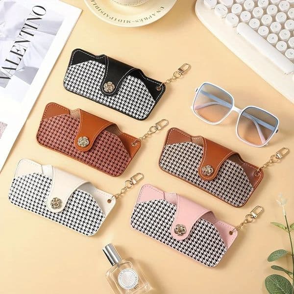 A stylish and minimalist PU leather glasses case with a chain for easy carrying and protection 260323