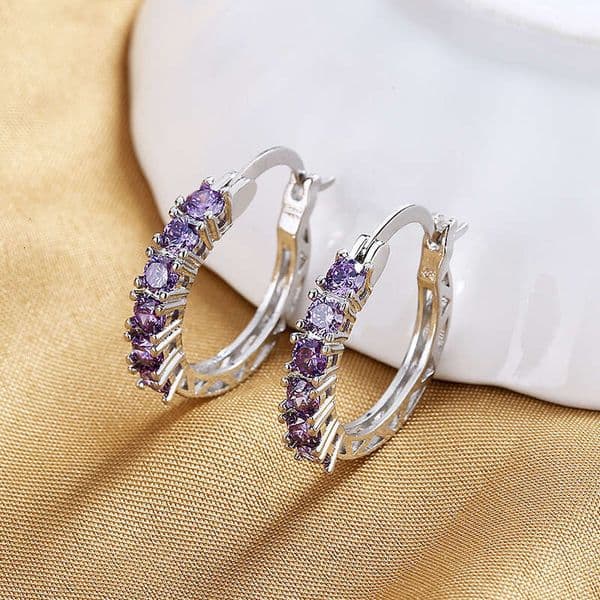 European and American cross-border best-selling fashion earrings for women, elegant circle hollow design with diamond-encrusted purple zircon ear clasps,