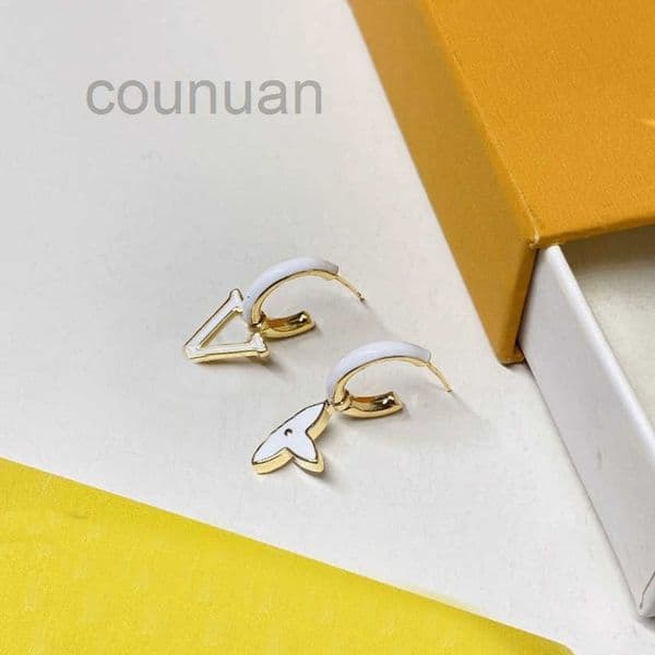 Gold - Toned Asymmetric Stud Earring with White Enamel Accents Delicate Playful Design for Daily Elegance or Subtle Party Charm High - Quality Stylish Jewelry Gif