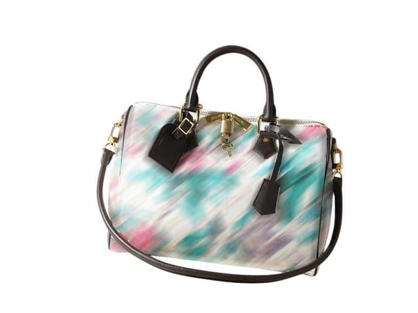 This designer handheld bag features a zippered interior pocket and a detachable shoulder strap for added refined details.