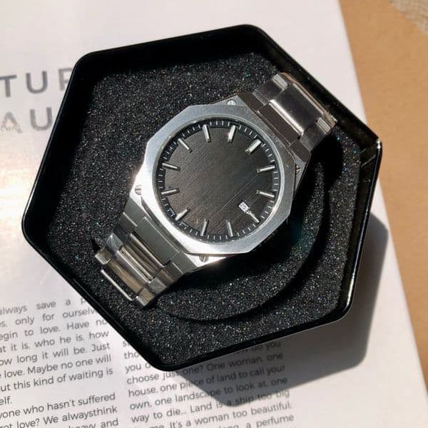 Men's wrist with brushed angular case polished stainless steel bracelet black matte textured dial smart sports watch