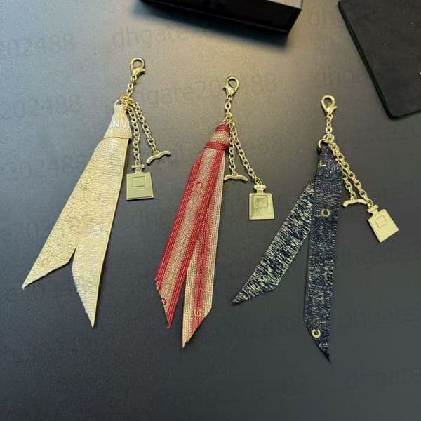 Fashion designer ribbon mobile phone lanyard High quality gold perfume bottle pendant Keychain for women Elegant anti lose decoration mobile phone pendant dhgate