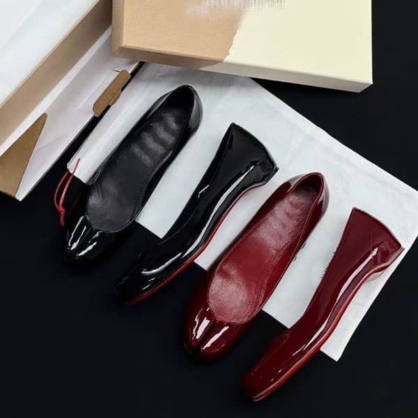 Designer Classic woman wearing a single pair of red ballet shoes with flat pig's feet, shallow-mouthed patent leather and one foot