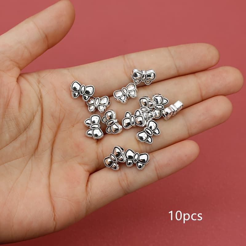 TEMU 10pcs Vintage Silvery Bow Charm Small Hole Beads Beaded Loose Beads Beads Decorative Beads Diy Crafts Handmade Make Bracelets Necklaces Accessories 12x8.5mm